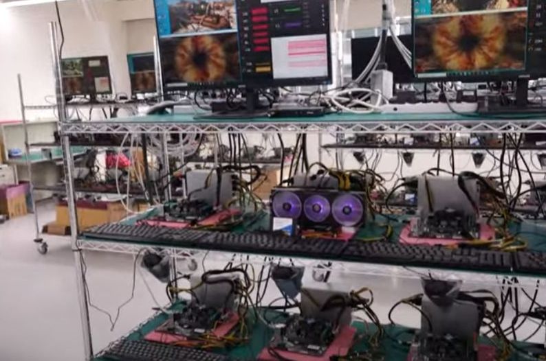 Hardware reviewer capturing GPU benchmark data on a test bench